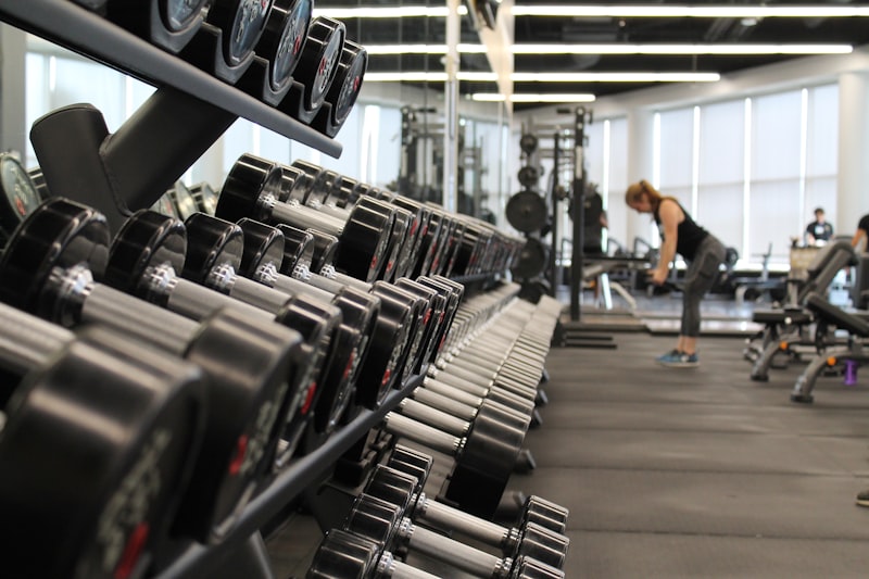 Free weights and training equipment in a bright gym